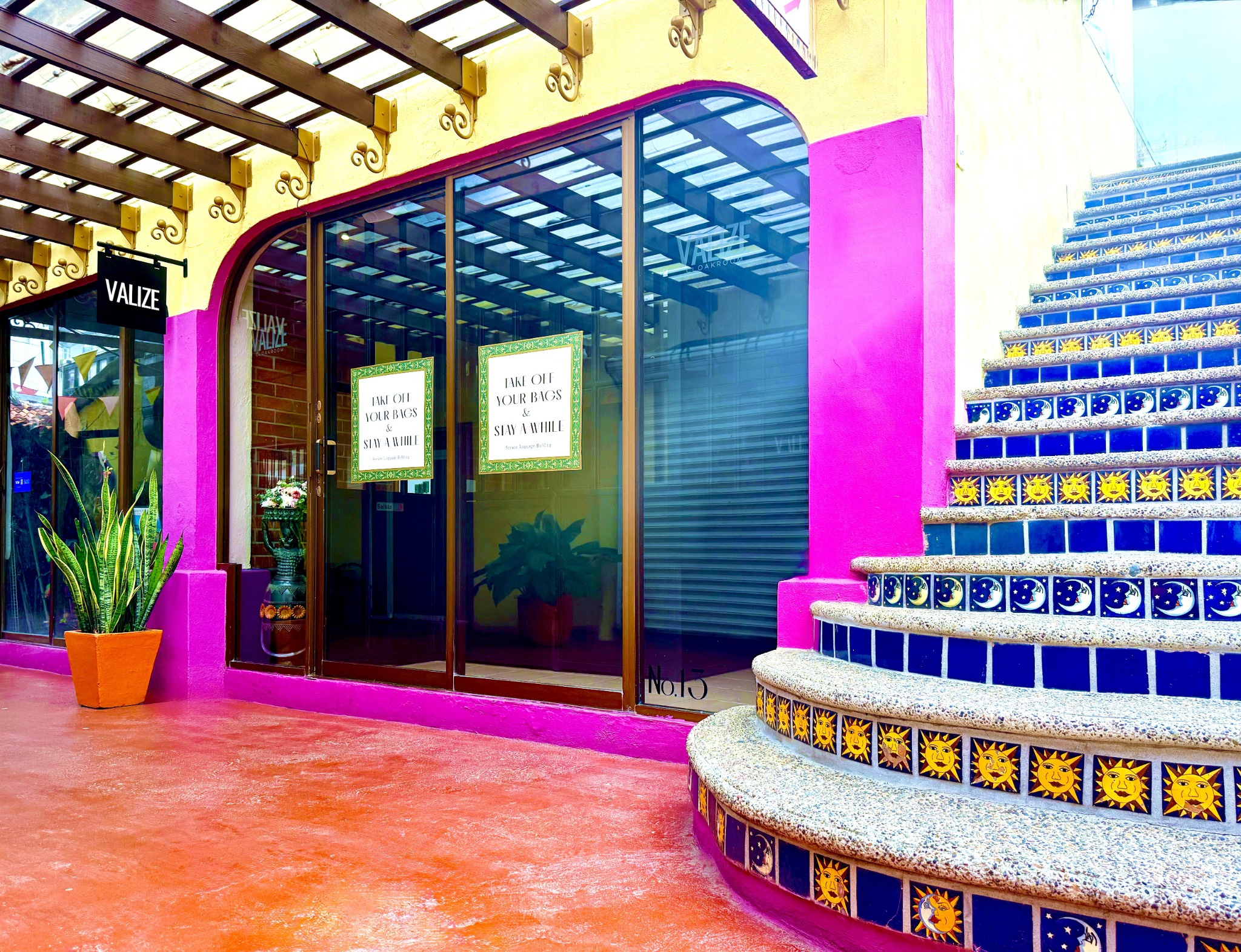 VALIZE Cloakroom storefront beside the distinctive tiled staircase at Plaza Romy